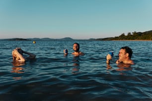 a couple of people floating on top of a body of water