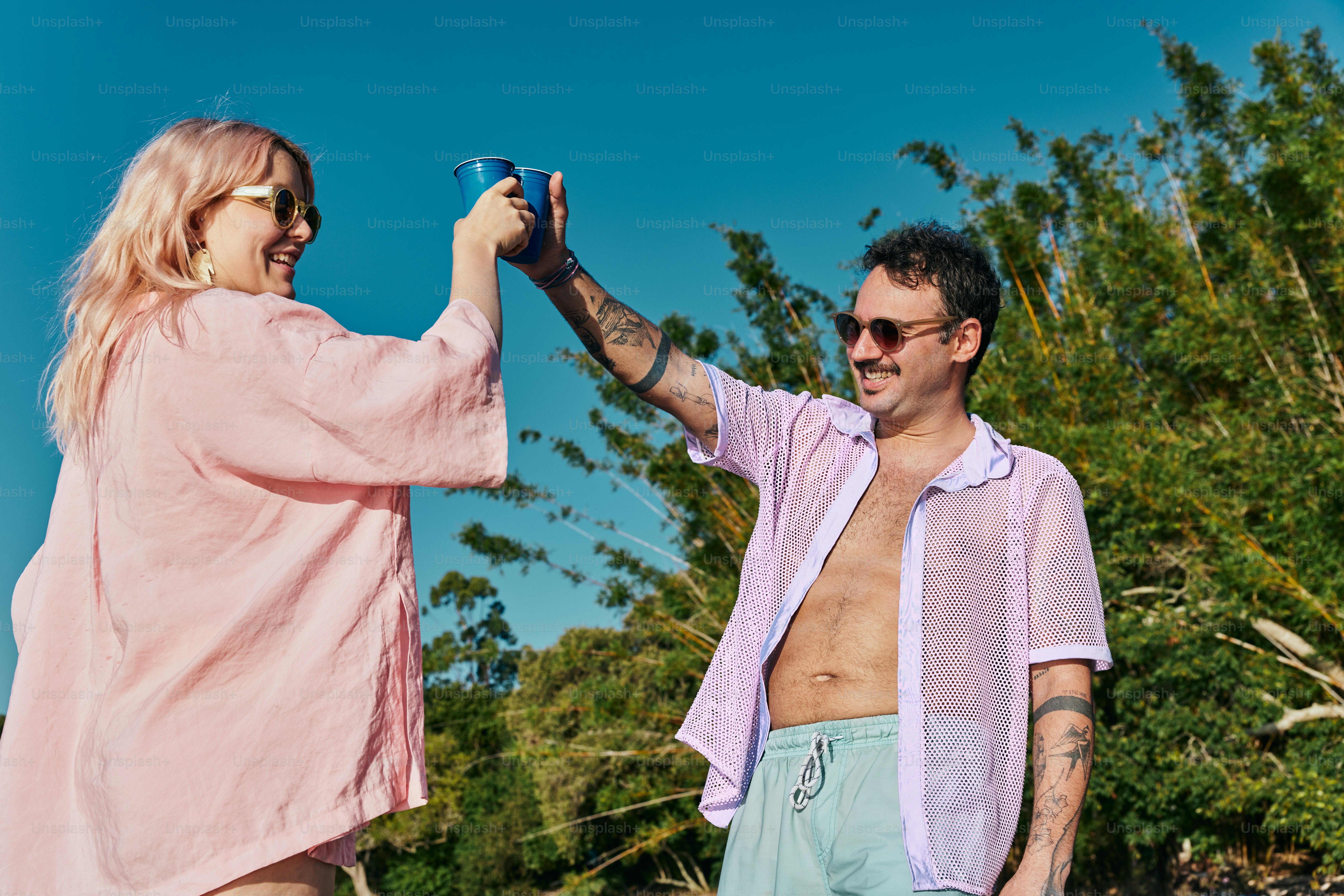 a man and a woman holding a blue cup