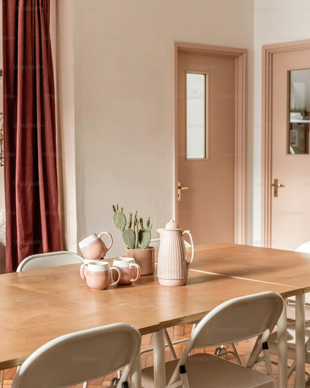 a dining room table with chairs and a vase on it