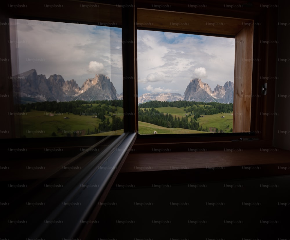 a window with a view of a mountain range