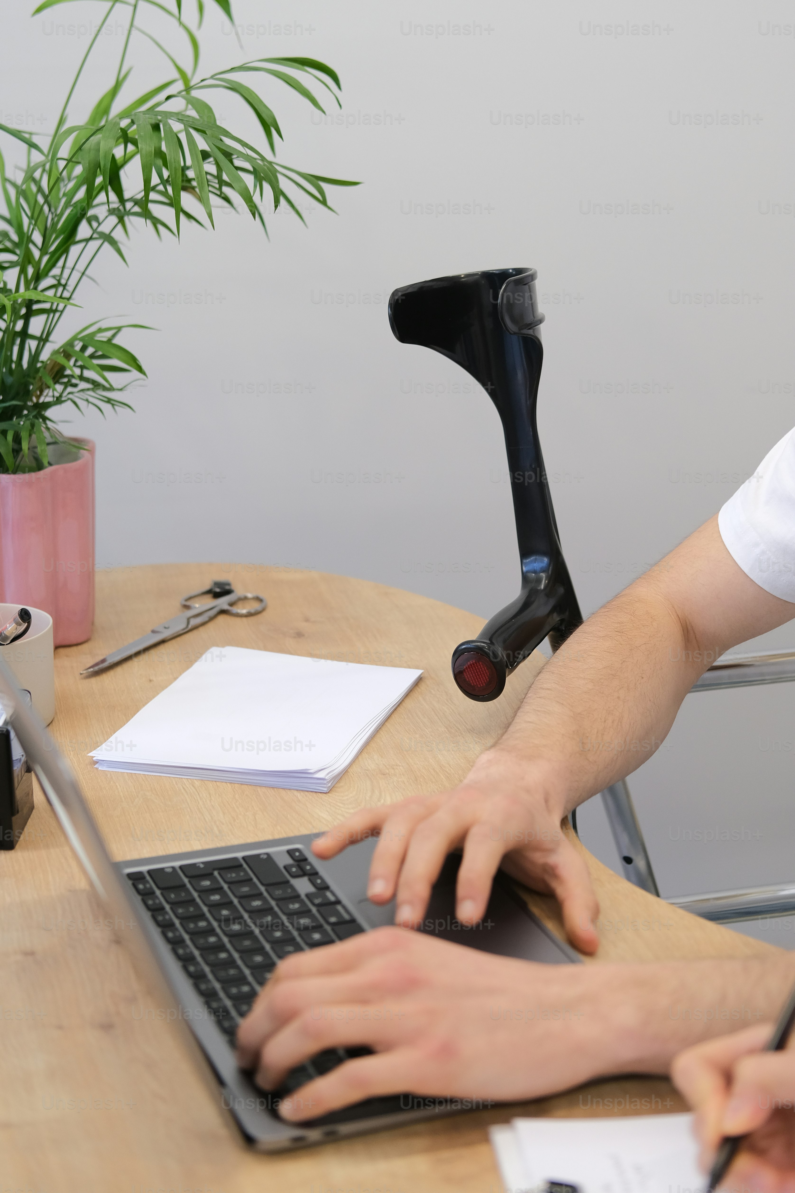 a person typing on a laptop on a wooden table