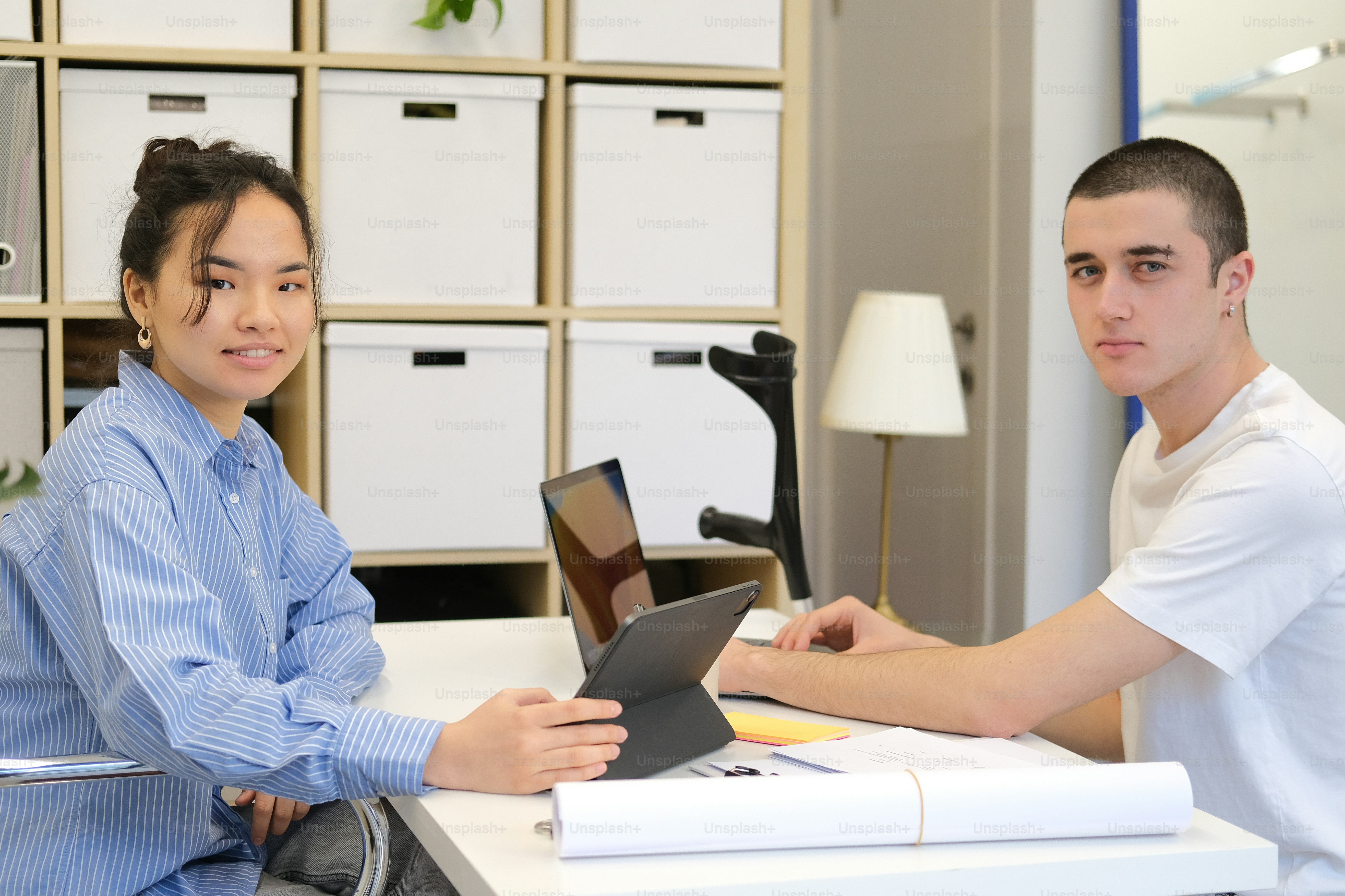 A woman sitting at a desk with a laptop computer photo – Woman Image on ...