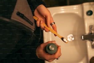 a person holding a toothbrush in their hand