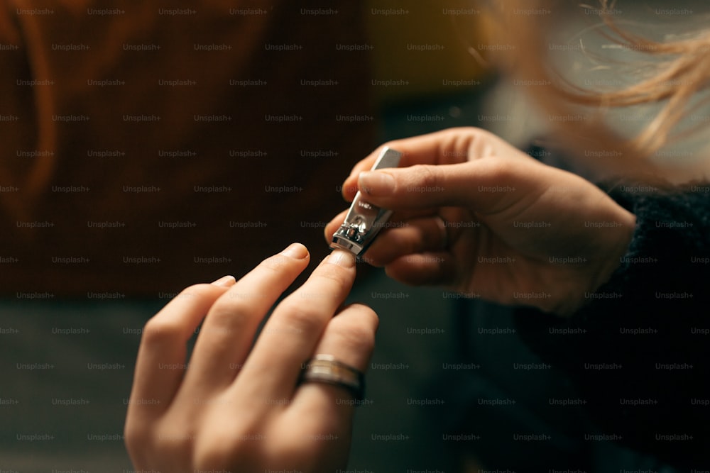 a woman is holding a cigarette lighter in her hand