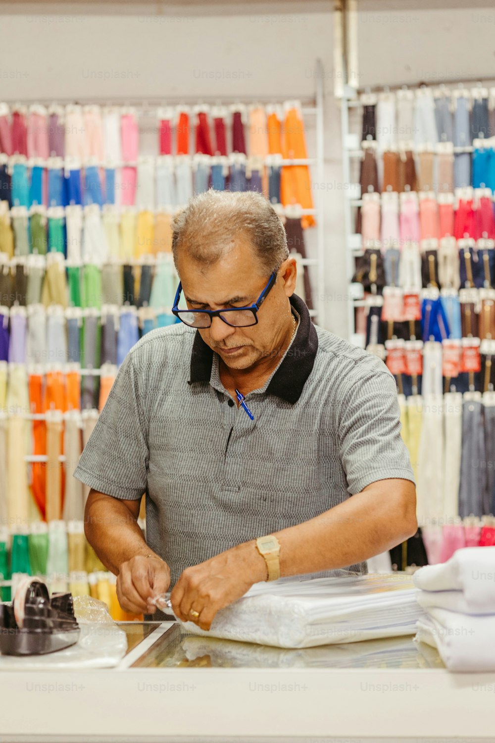 a man working on a pair of shoes in a store