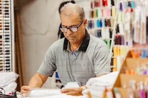 a man working on a piece of paper in a store