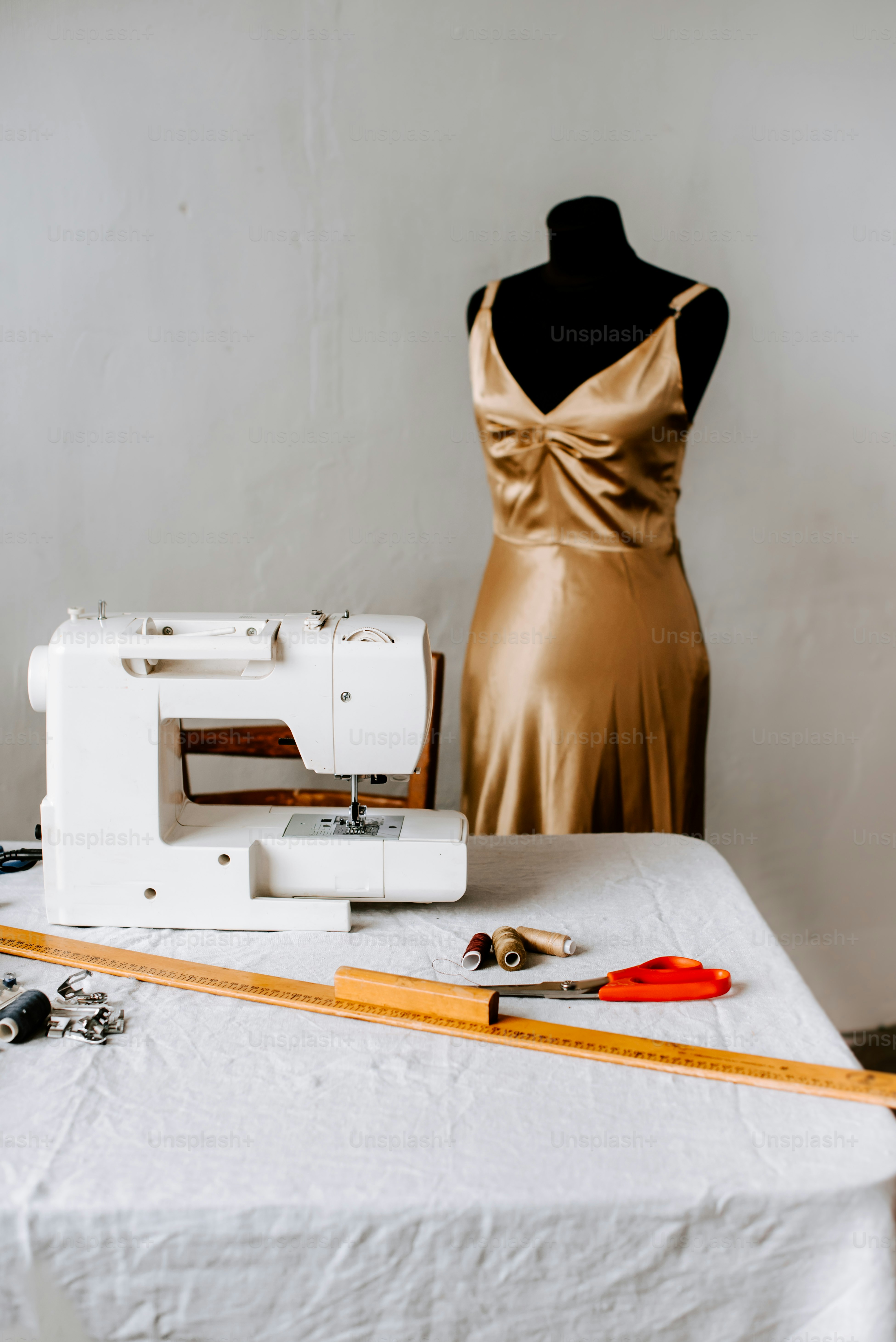 A sewing machine sitting on top of a white table photo Fashion