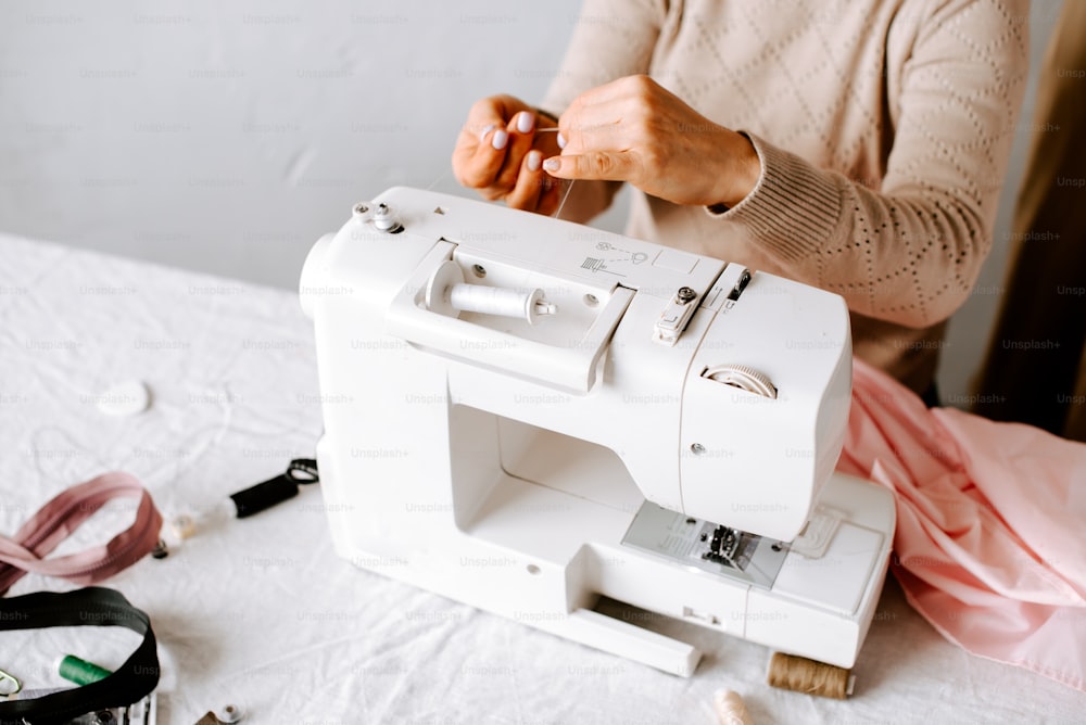 a woman using a sewing machine on a table