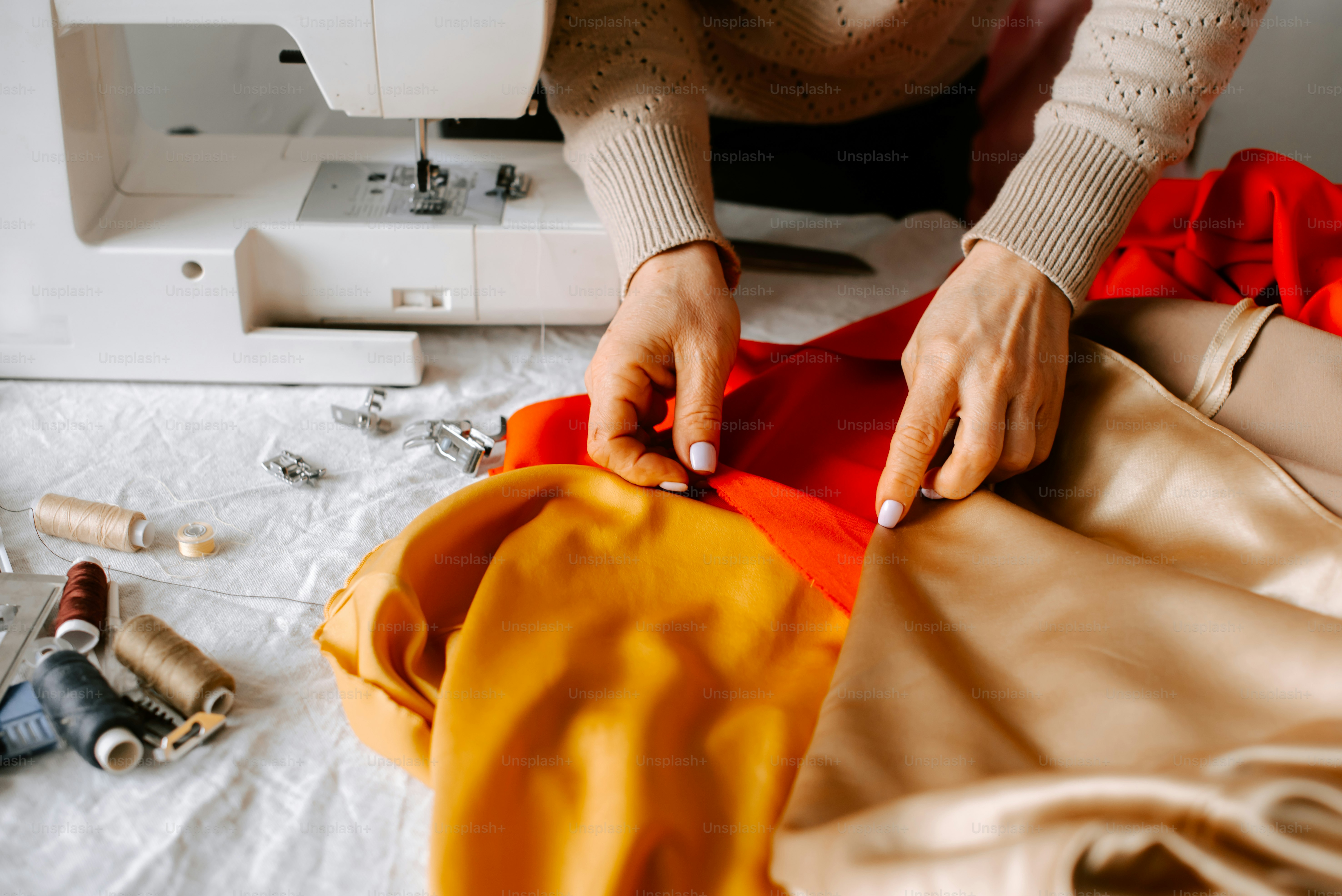 a woman is working on a piece of cloth