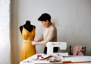 a woman working on a dress on a sewing machine