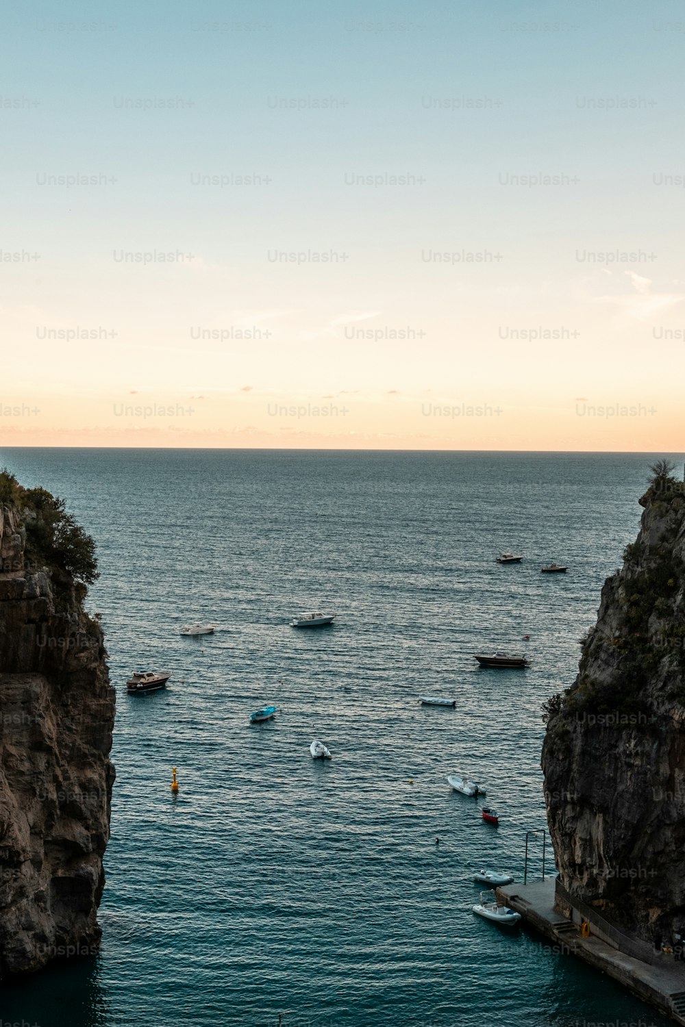 a group of boats floating on top of a large body of water