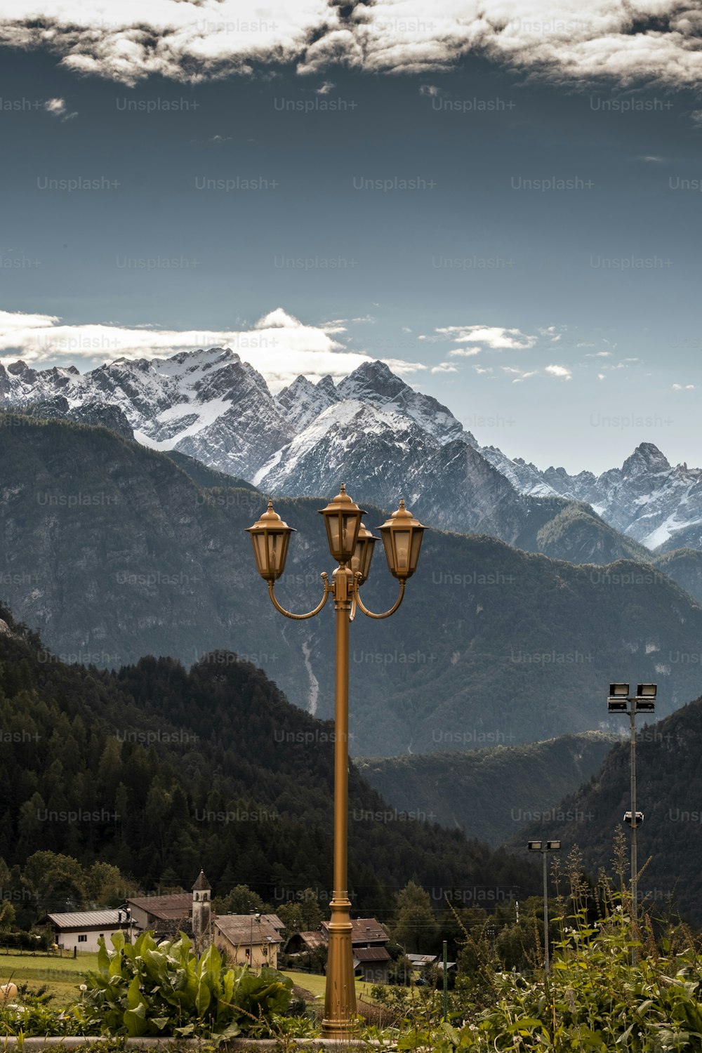 a street light in front of a mountain range