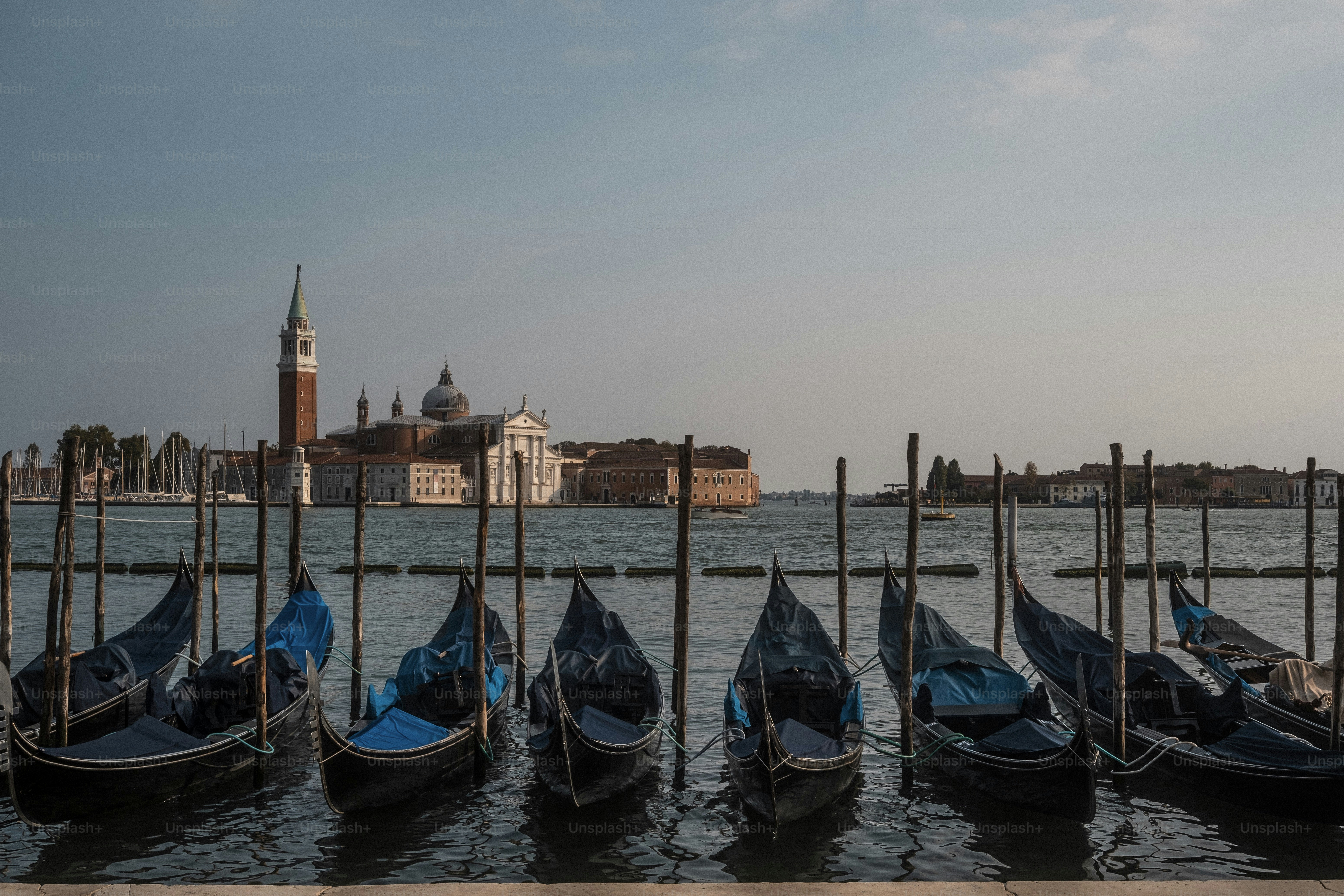 a row of gondolas sitting on top of a body of water