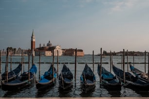 a row of gondolas sitting on top of a body of water