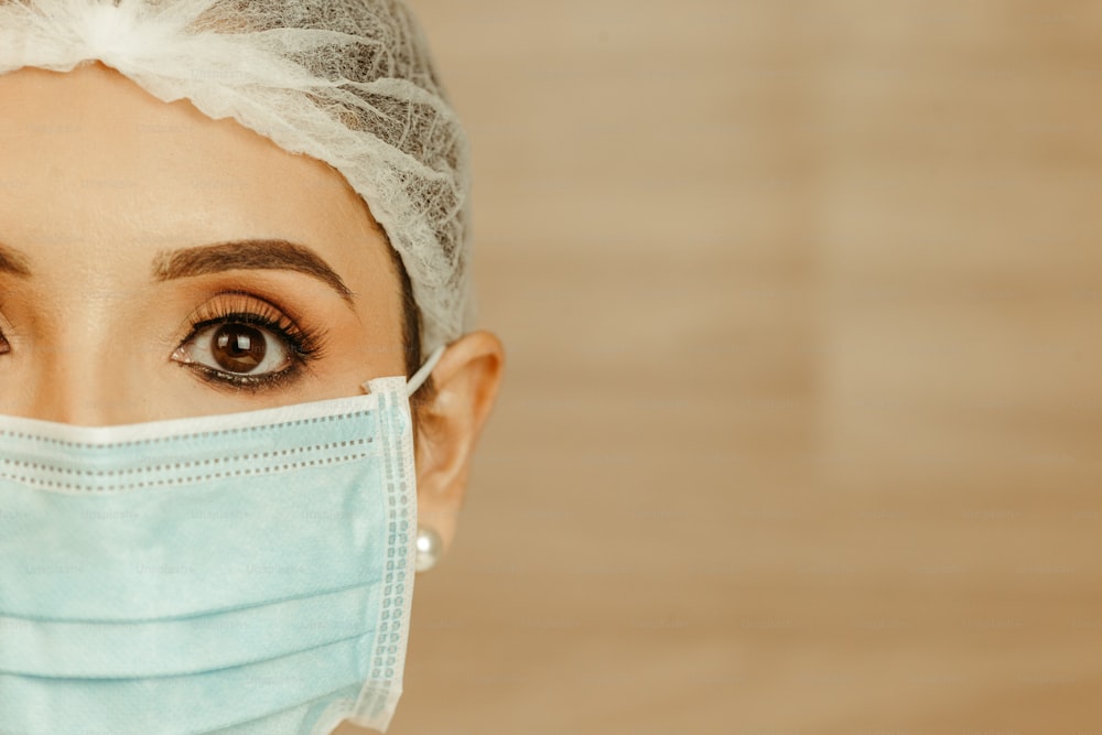 a woman with a surgical mask on her face