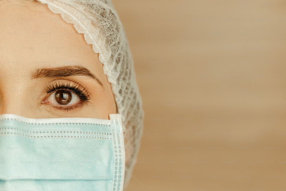 a close up of a person wearing a surgical mask