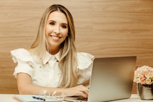 uma mulher sentada na frente de um computador portátil