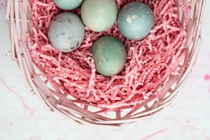 a basket filled with eggs sitting on top of a table