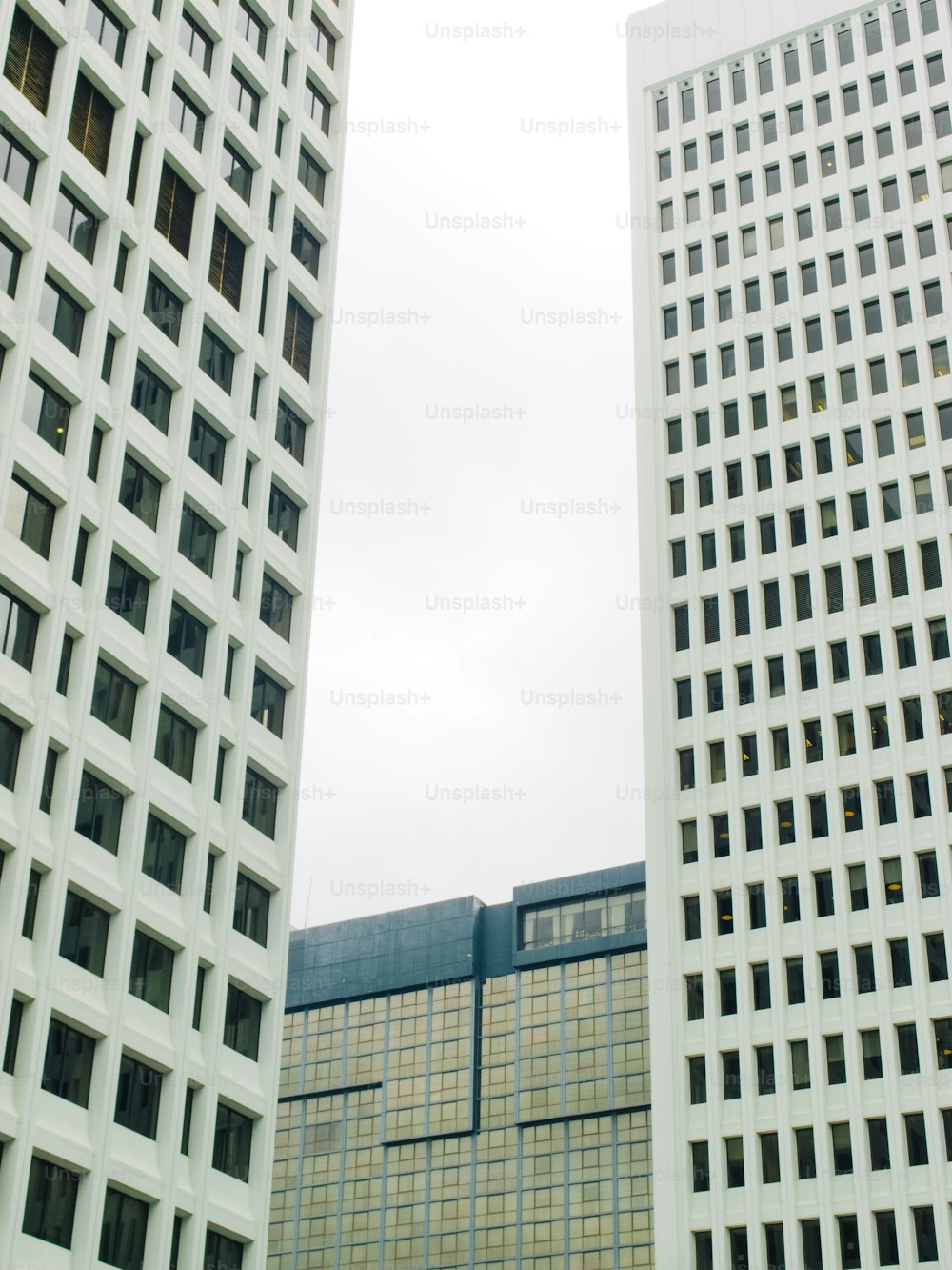 a couple of tall buildings sitting next to each other