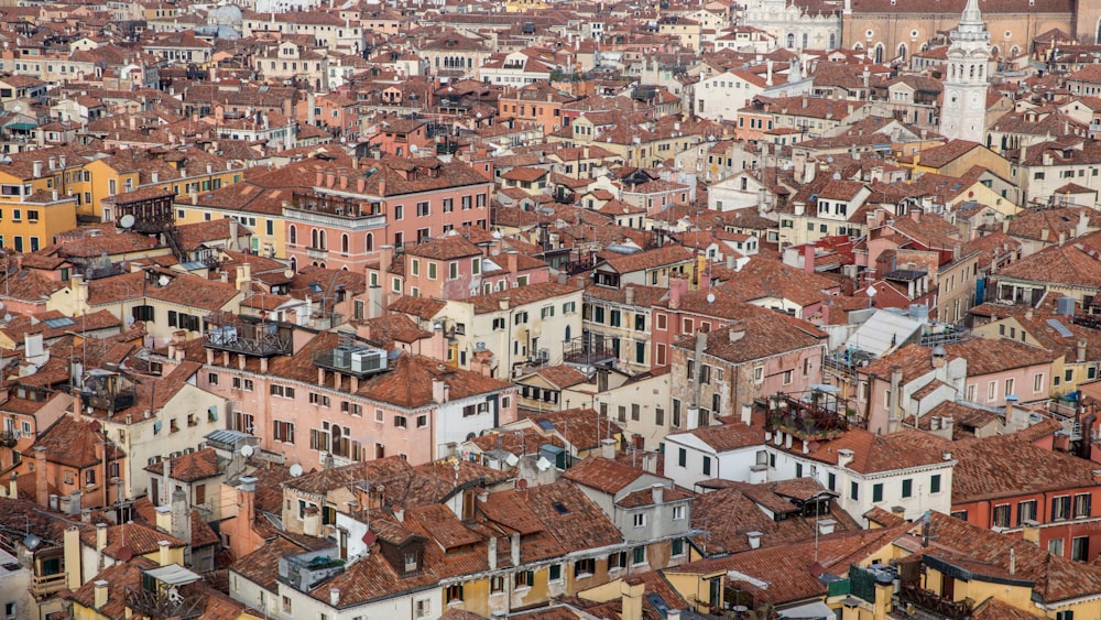 a large group of buildings with a clock tower in the background