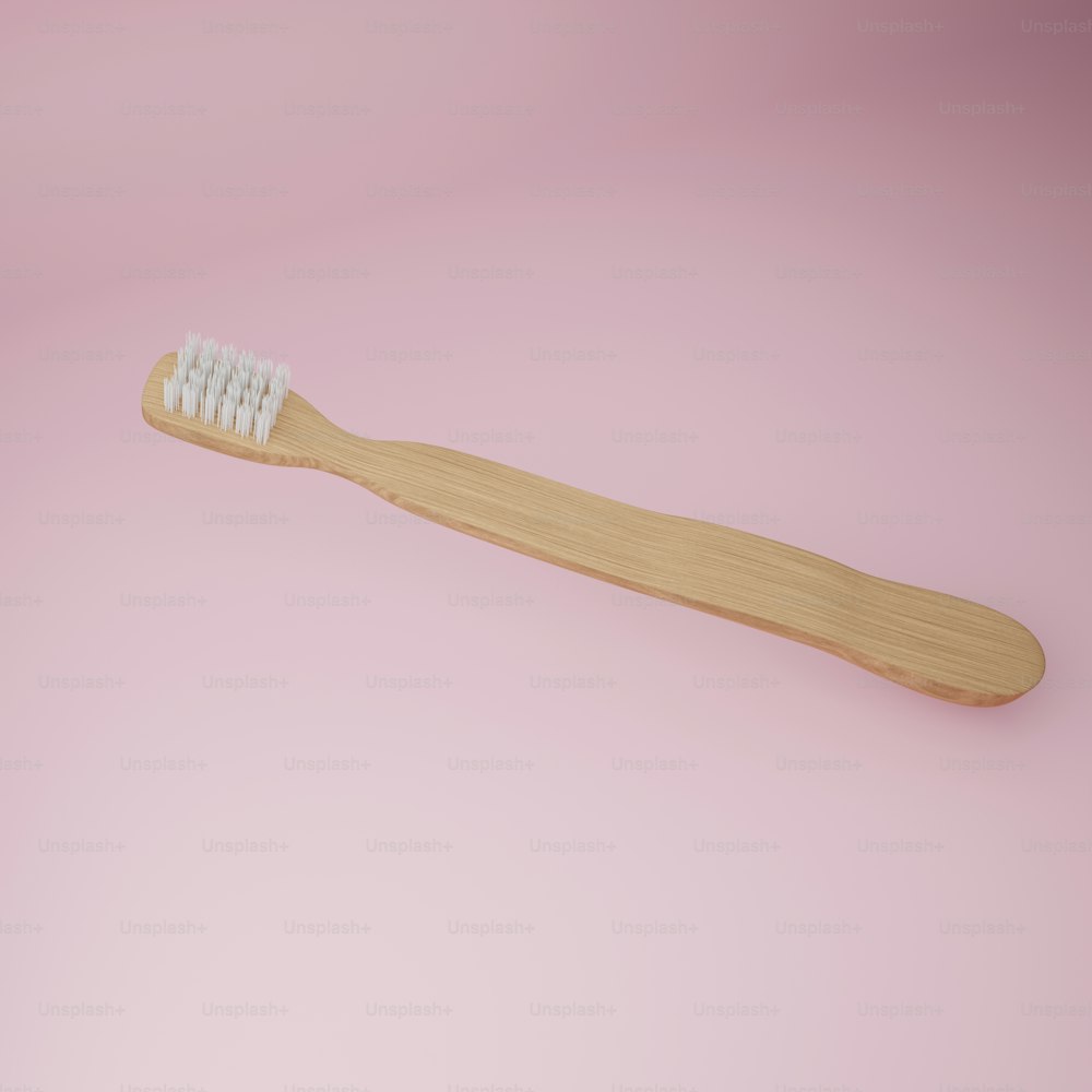 a toothbrush on a pink background