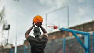 a man holding a basketball up in the air