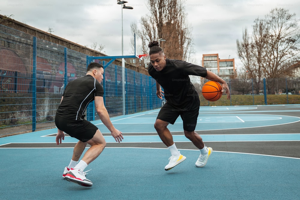 a couple of men playing a game of basketball