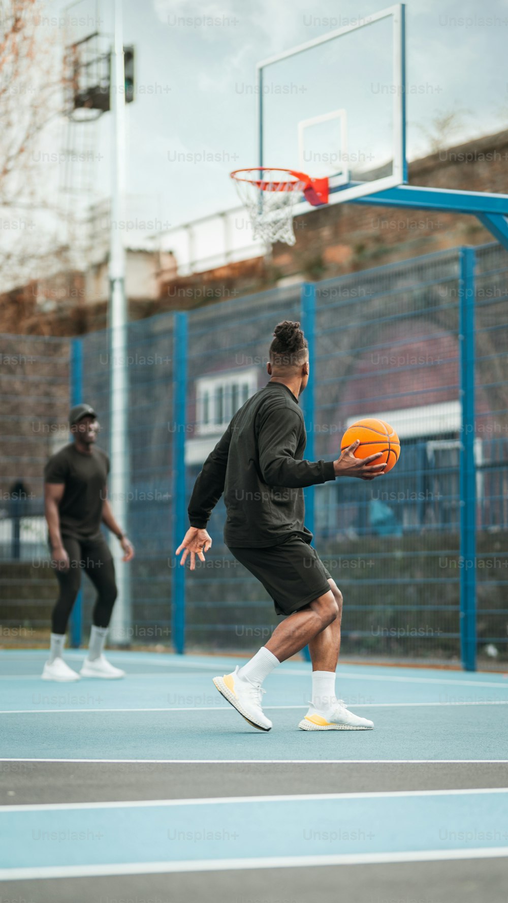 a man holding a basketball while standing on a basketball court