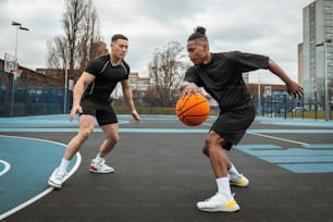 a couple of men playing a game of basketball