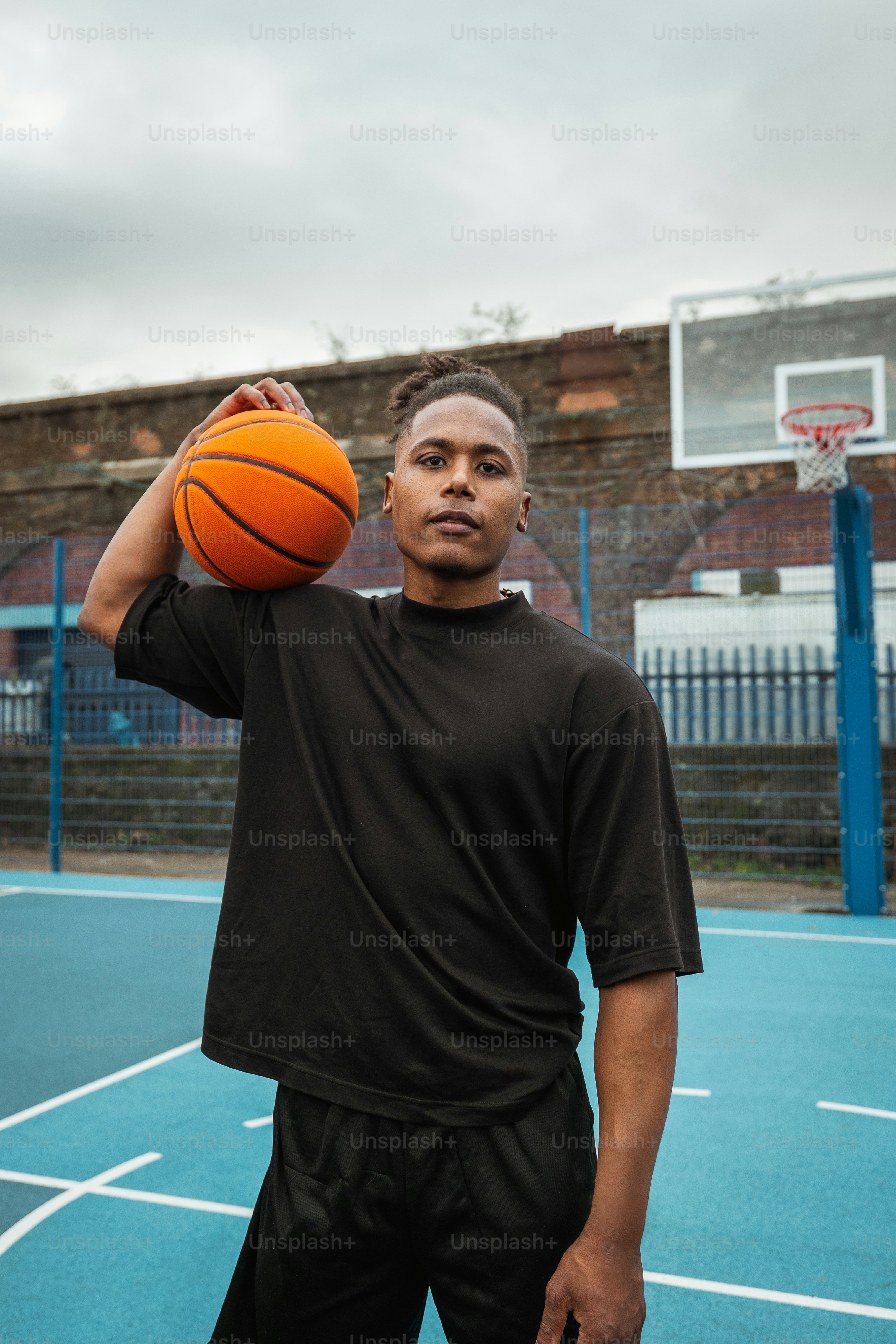 a man holding a basketball on a basketball court