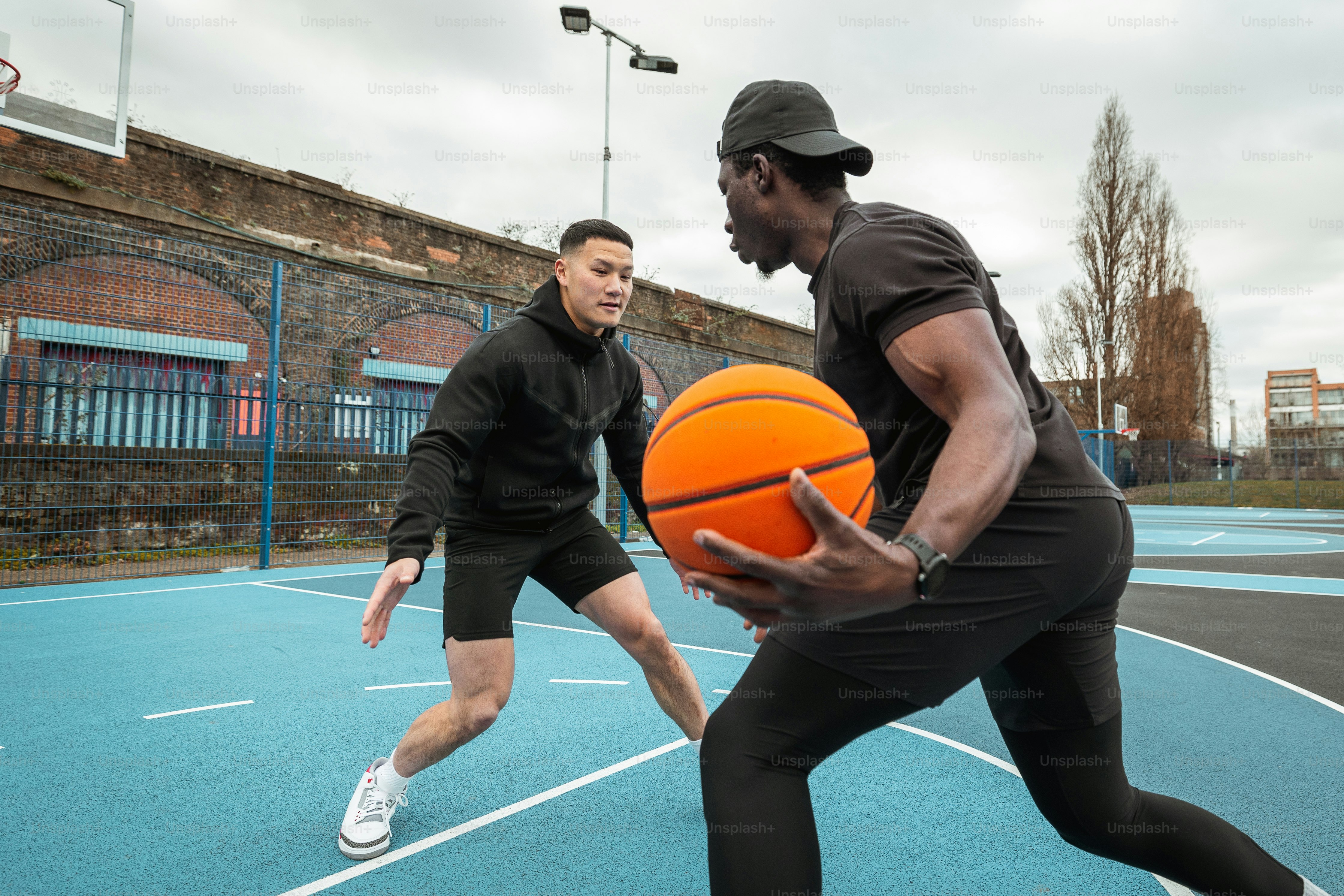 a couple of men playing a game of basketball