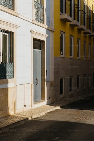 a yellow building with a blue door and windows