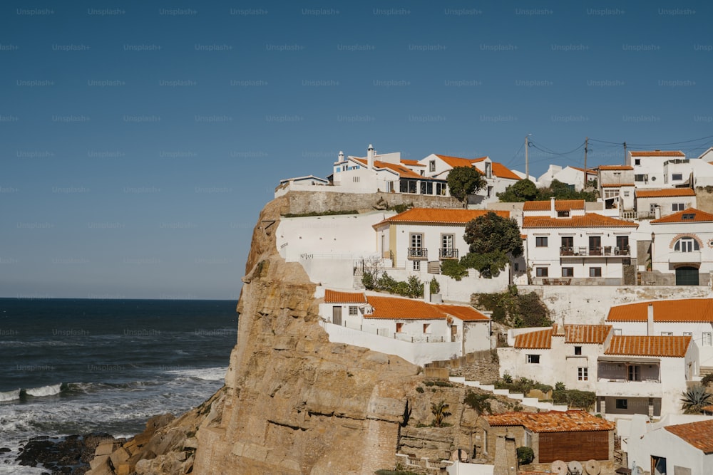 a view of a village on a cliff near the ocean