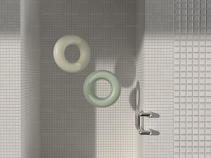 a bathroom with a white tiled wall and a green and white toilet