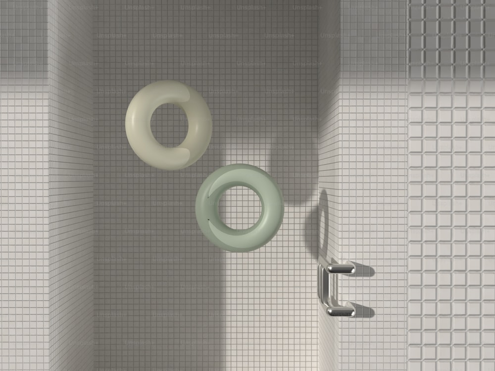 a bathroom with a white tiled wall and a green and white toilet