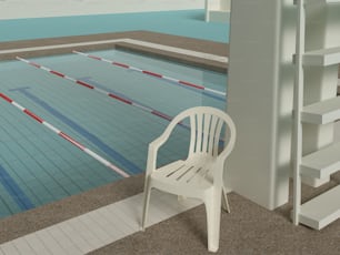 a white chair sitting next to a swimming pool