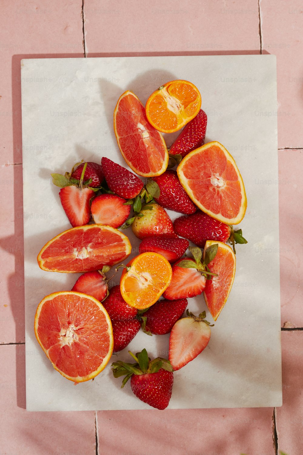 a bunch of cut up fruit sitting on top of a table