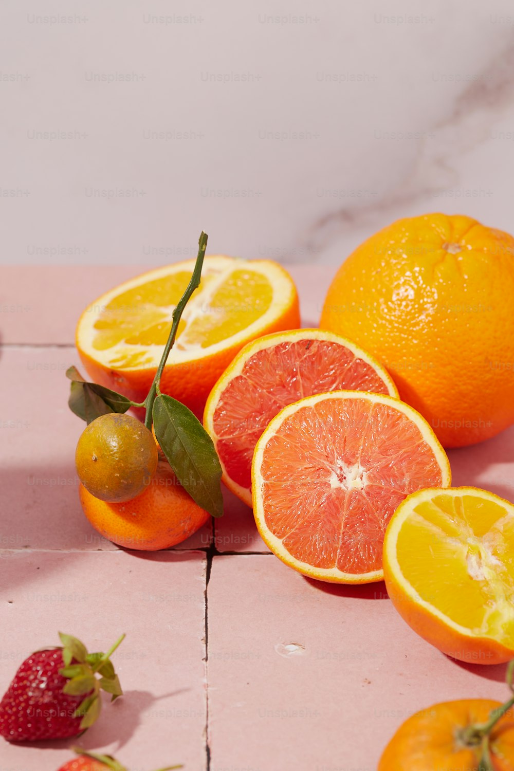 a bunch of oranges and strawberries on a table