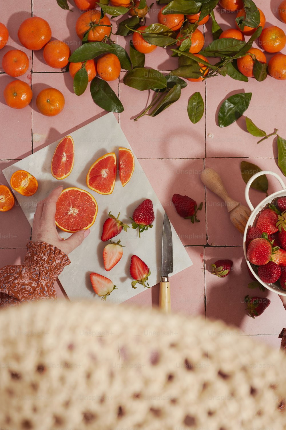 a table topped with sliced up oranges and strawberries