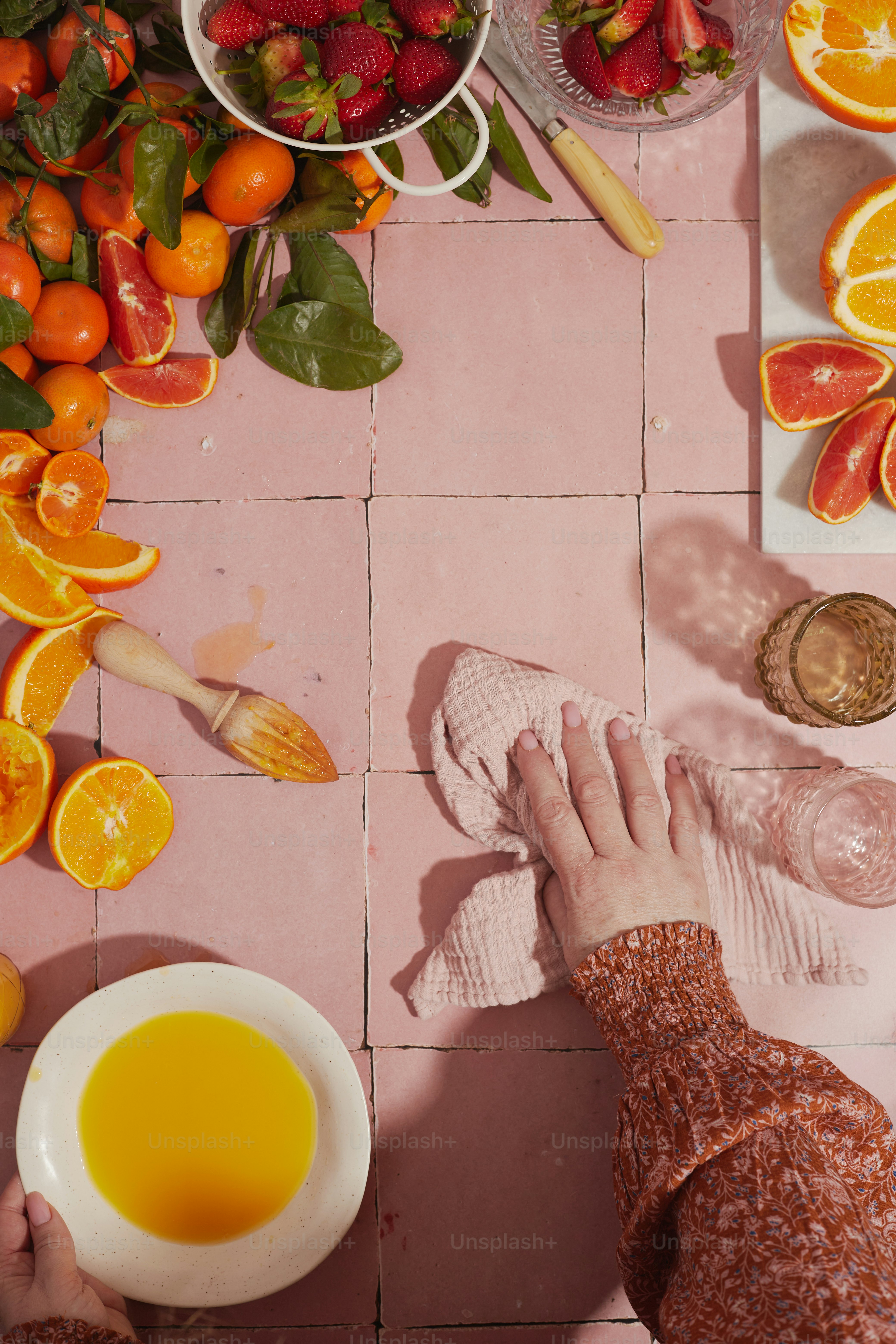 a person is washing their feet in a bowl of orange juice