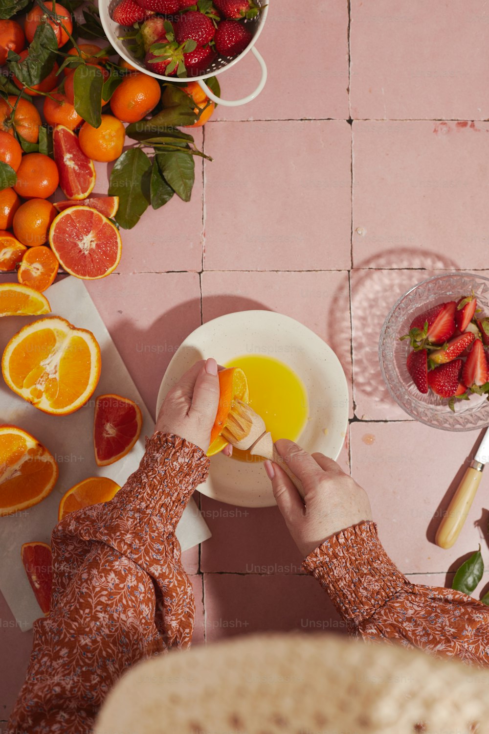 a woman is peeling an orange slice on a plate