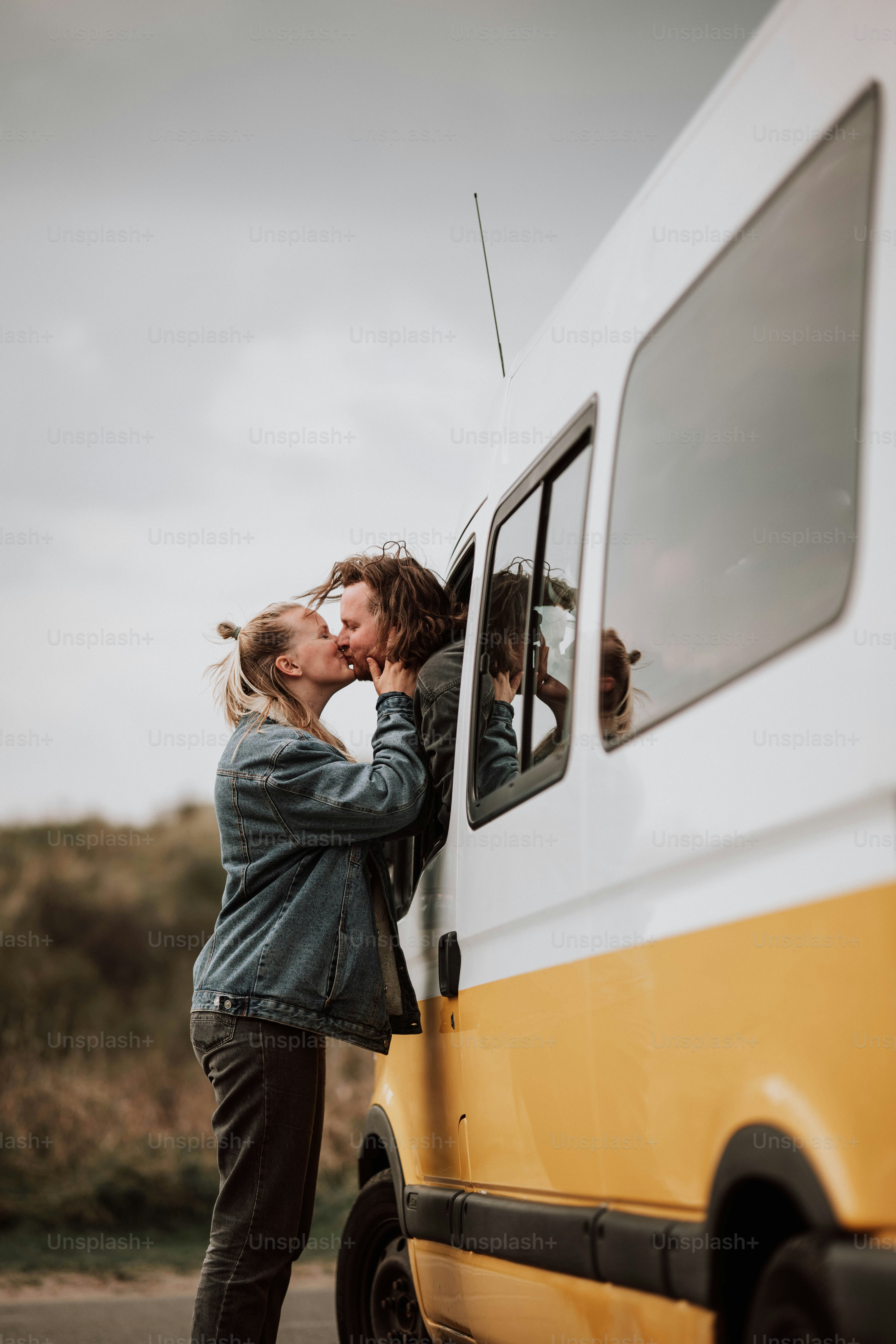 a couple of people that are kissing in the back of a van