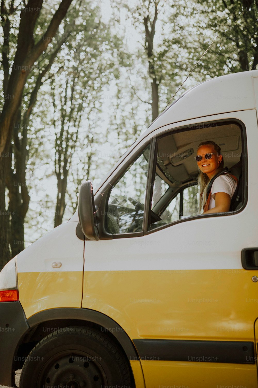 a woman sitting in the driver's seat of a van