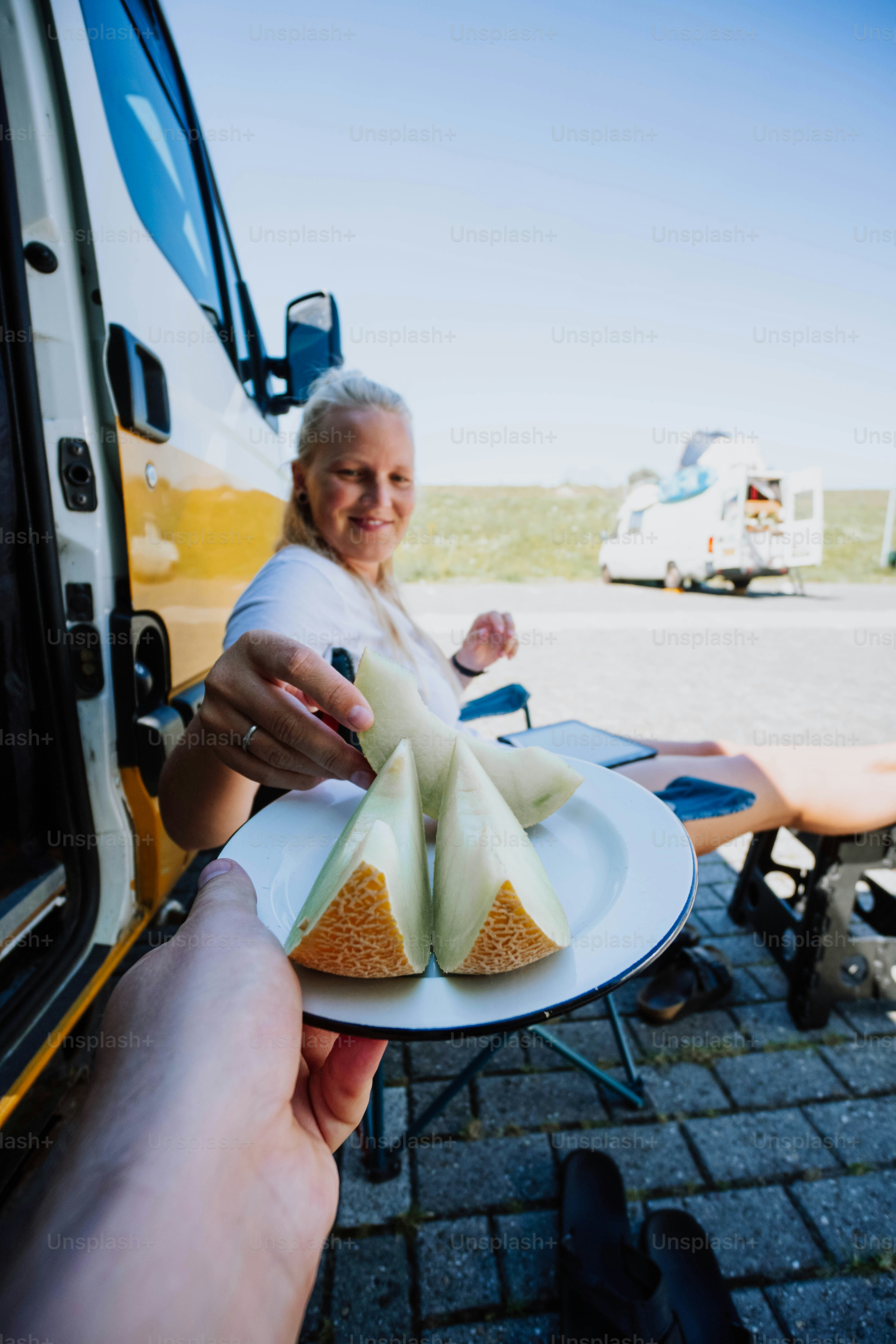 a person holding a plate with food on it