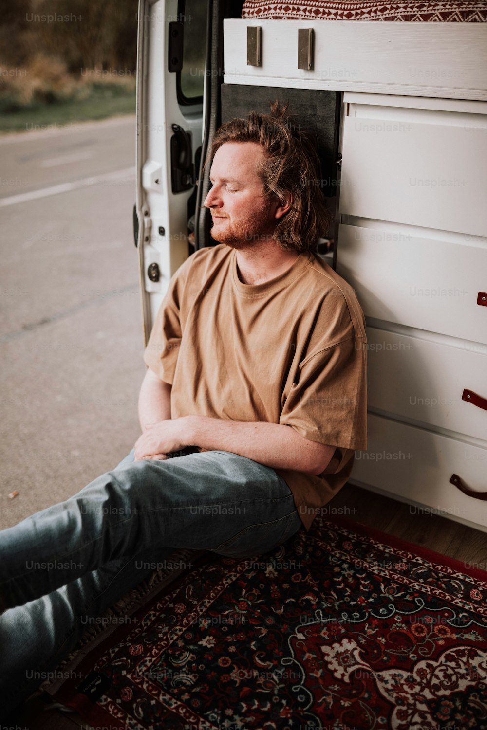 a man sitting in the back of a van