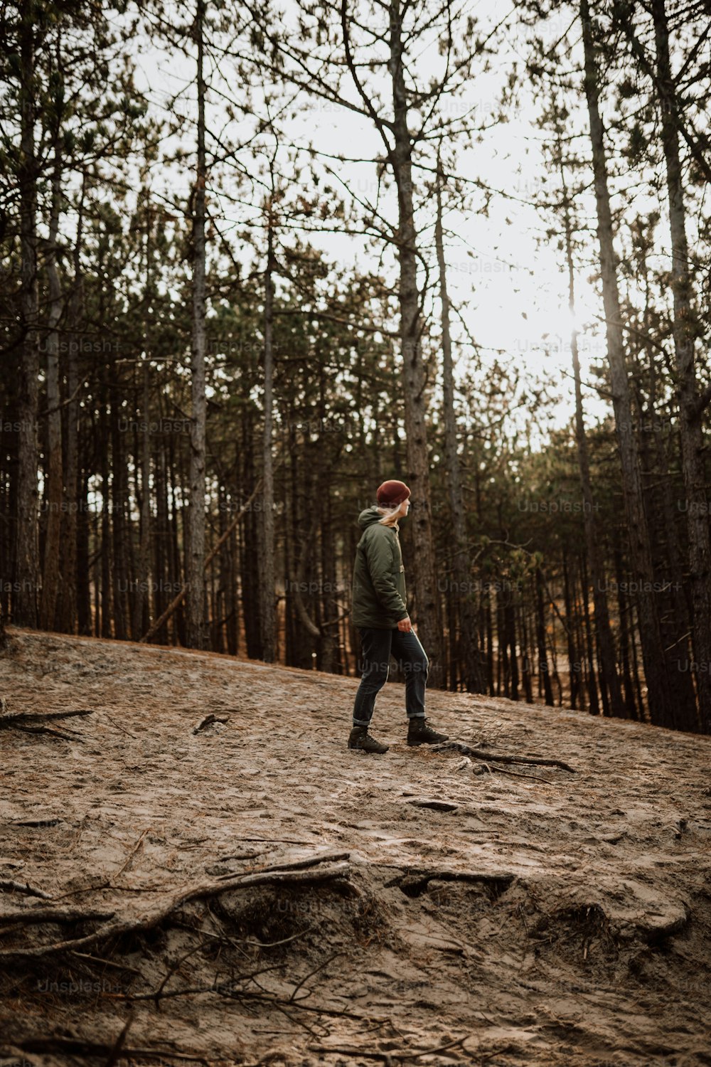 a man standing on top of a dirt hill