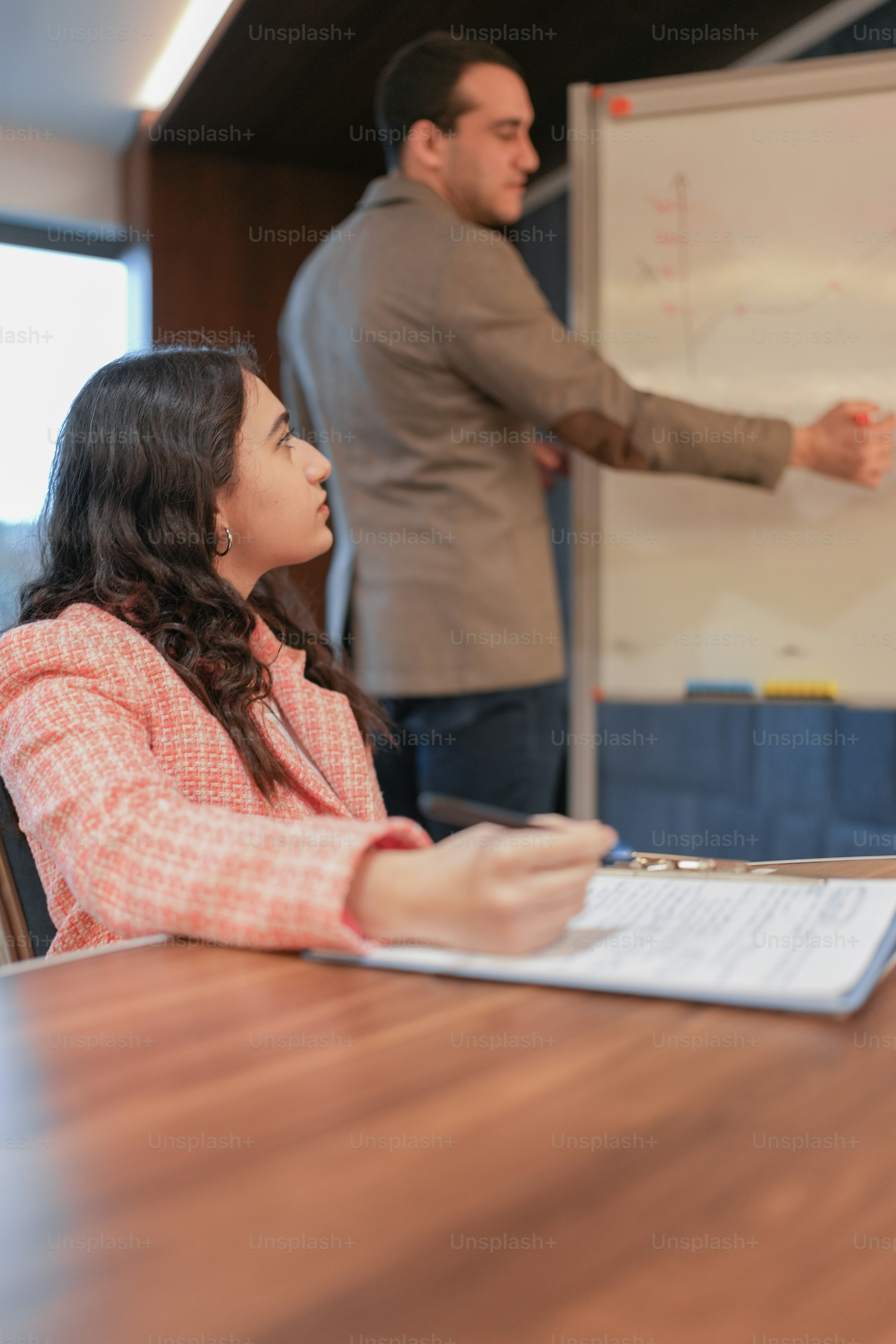 a woman sitting at a table in front of a man