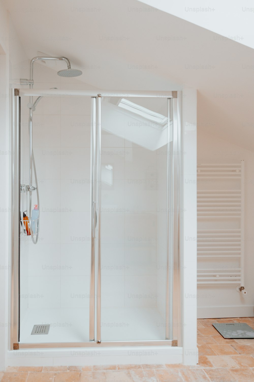 a white bathroom with a walk in shower