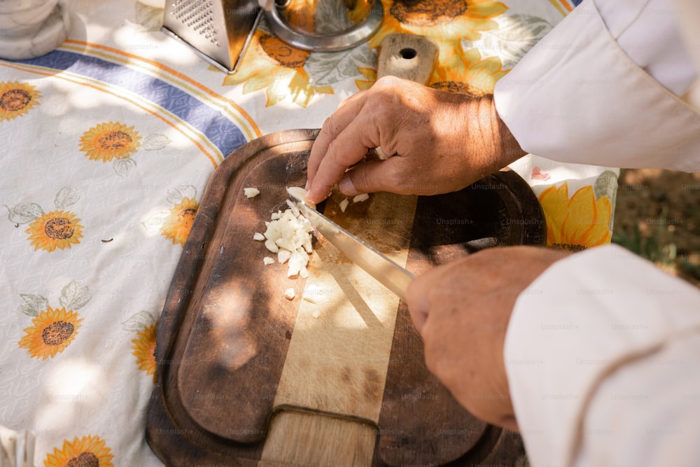 a person chopping onions on a cutting board