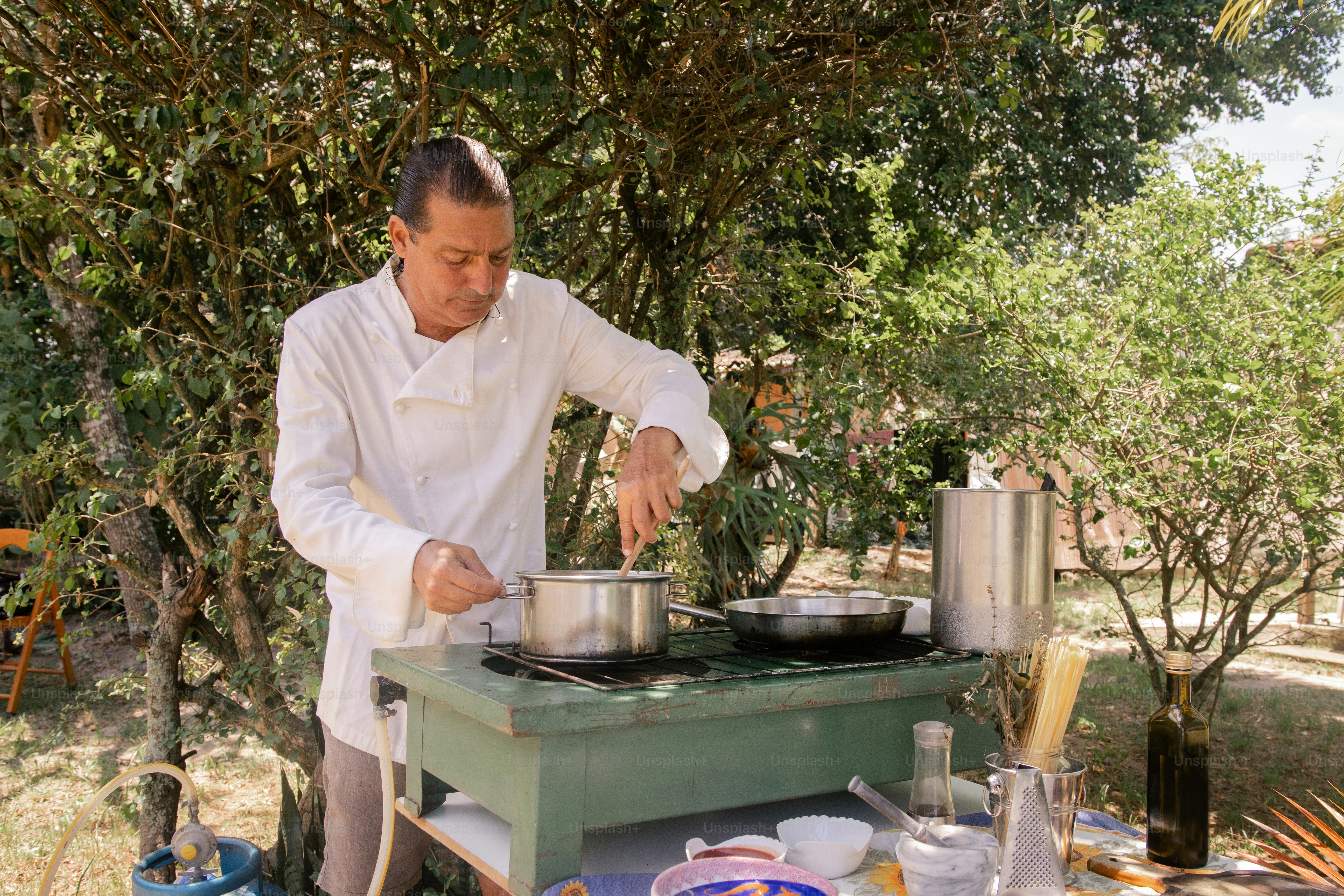 a man cooking food on top of a stove